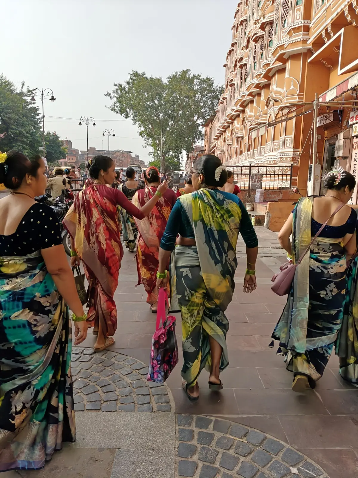 Women in colourful sarees walking through Jaipur's old city
