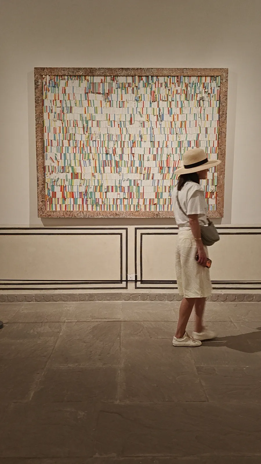 Visitor viewing an artwork in a gallery at the City Palace, Jaipur