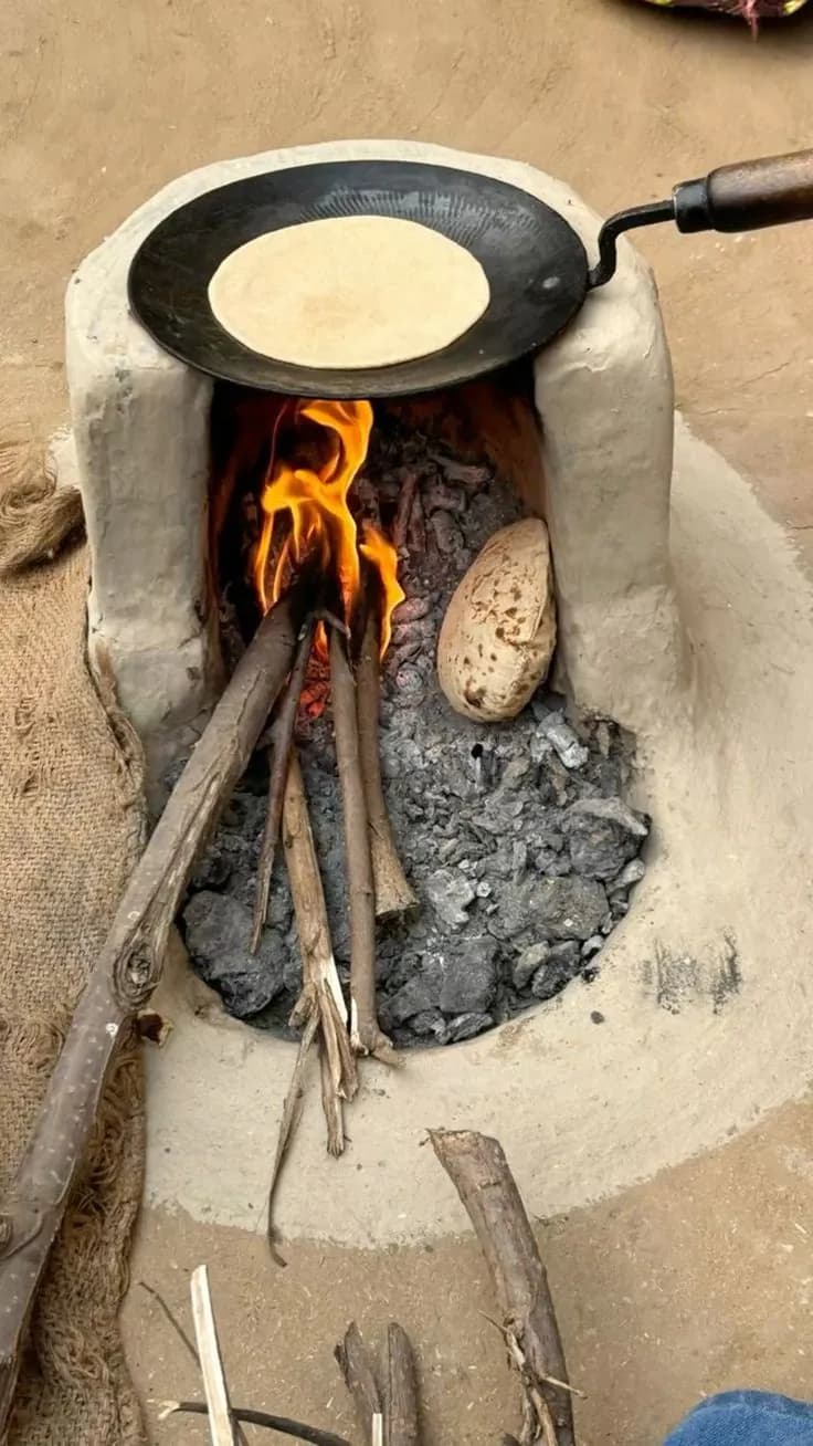 Roti on an iron tawa over a wood fire