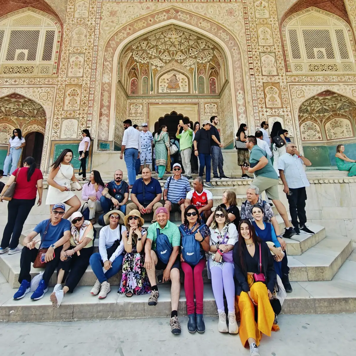 Group of Raah guests in front of the painted Ganesh Pol, Amer Fort
